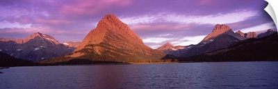 Lake with mountains at dusk, Swiftcurrent Lake, Many Glacier, US Glacier National Park, Montana,