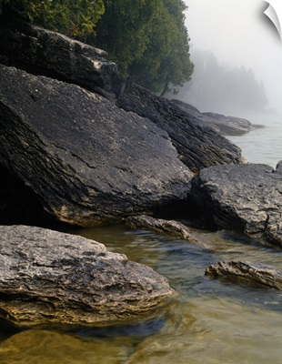Large boulders on misty Lake Michigan shoreline, Newport Bay, Newport State Park, Wisconsin