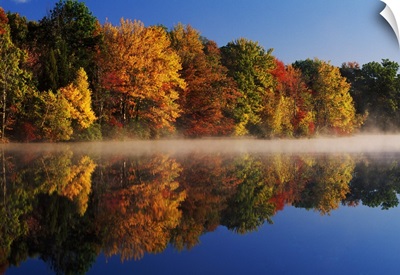 Layer of mist on Hidden Lake, autumn color trees with water reflection, Delaware Water Gap National Recreation Area, Pennsylvania