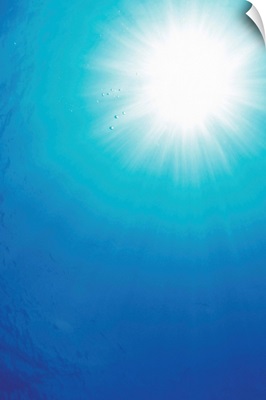 Looking up at the sun from underneath the water