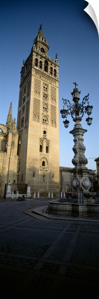 Low angle view of a lamppost in front a church, La Giralda, Seville Cathedral, Seville, Seville Province, Andalusia, Spain