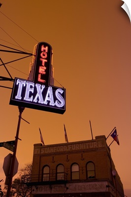 Low angle view of a neon sign of a hotel lit up at dusk, Fort Worth Stockyards, Fort Worth, Texas