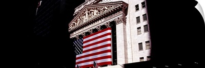 Low angle view of an American flag on a financial building, New York Stock Exchange, Wall Street, Manhattan, New York City, New York State