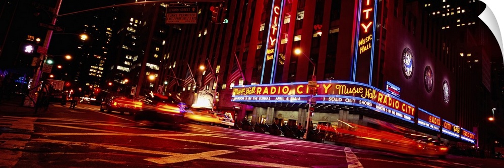 Low angle view of buildings lit up at night, Radio City Music Hall, Rockefeller Center, Manhattan, New York City, New York...