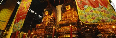 Low angle view of golden Buddha statues, Heavenly King Hall, Jade Buddha Temple, Shanghai, China