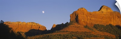 Low angle view of Moon over red rocks, Sedona, Arizona