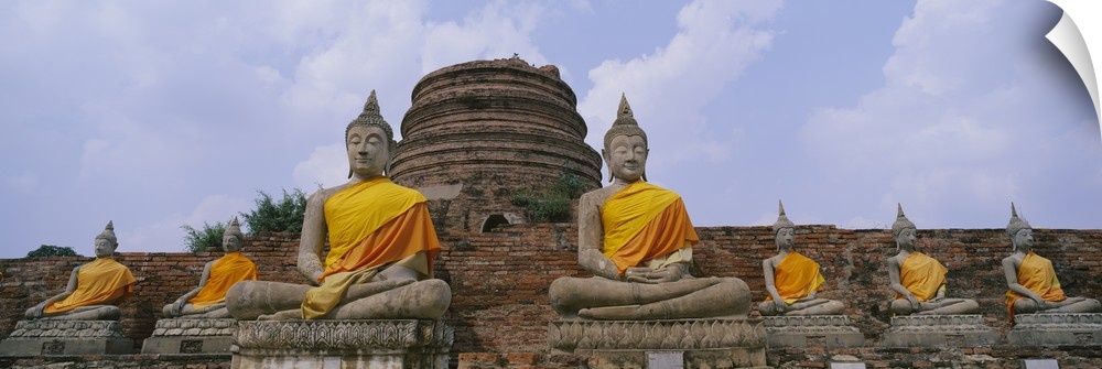Low angle view of statues of Buddha in a temple, Thailand