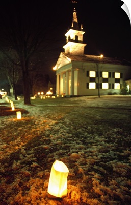 Luminaries outside small church at night, winter, Connecticut