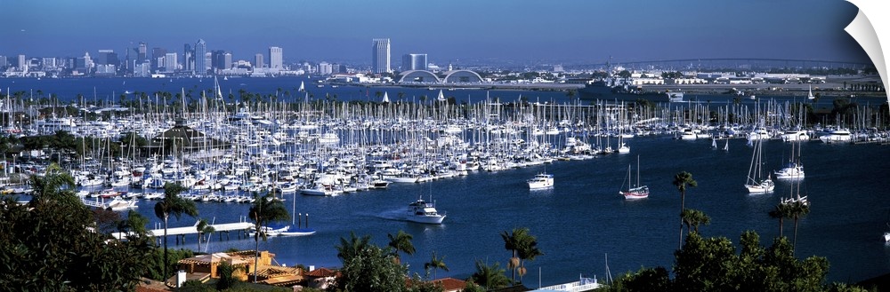 Panoramic photograph on a large wall hanging of a marina packed with boats, in front of the San Diego skyline on the dista...