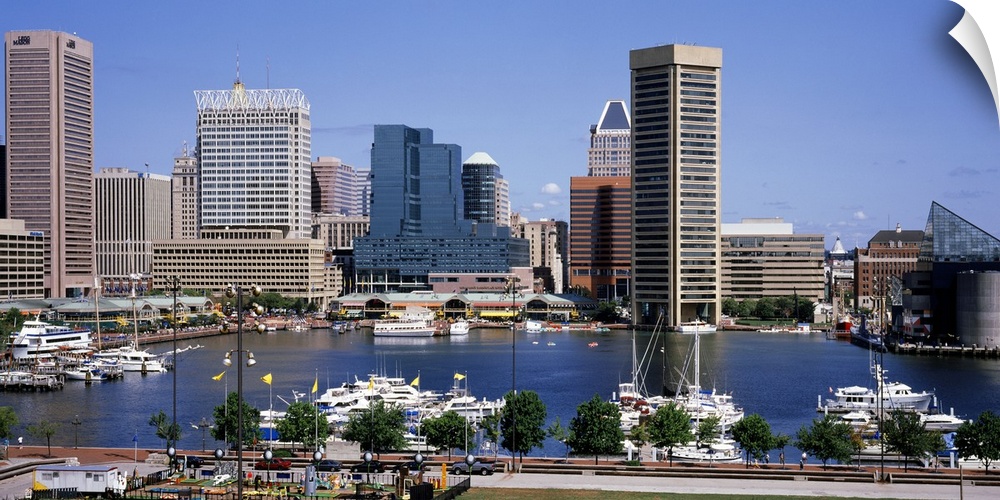 Image of the inner Baltimore harbor skyline with boats parked in the marina waters.