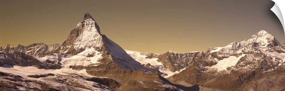 Large, landscape photograph of Matterhorn mountain, lightly covered with snow, in Switzerland.