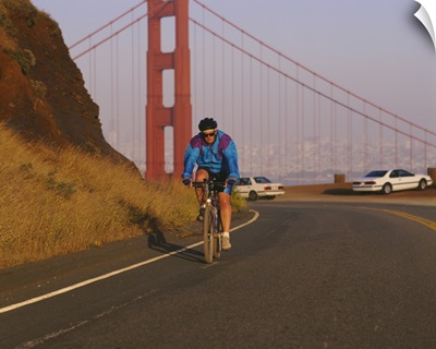 Mid adult man cycling, Golden Gate Bridge, San Francisco, California
