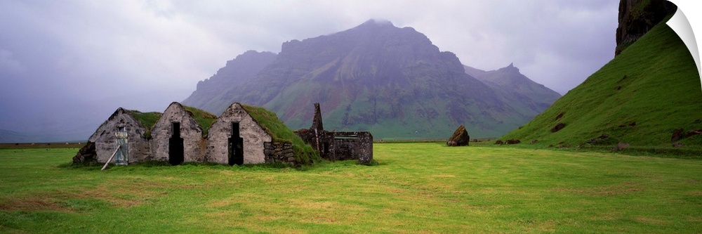 Misty mountain landscape with stone huts, Iceland