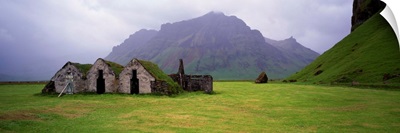 Misty mountain landscape with stone huts, Iceland