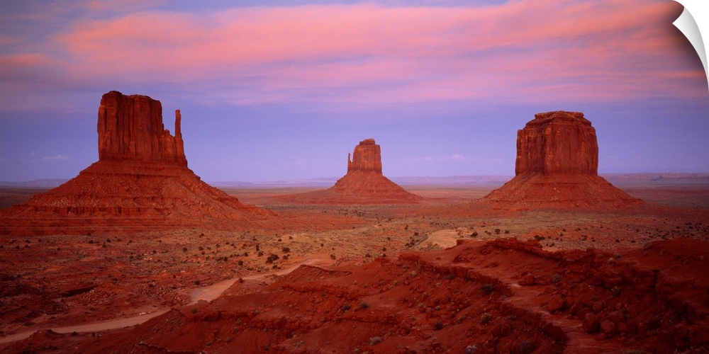 An oversized piece that is a photograph taken of Monument Valley during sundown.