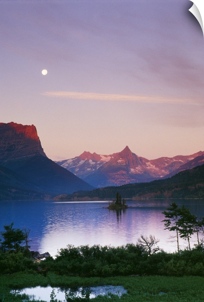 Big, portrait photograph of Saint Mary's Lake in Glacier National Park.  The moonlight is reflecting the mountains in the ...