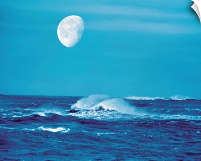 Moon over waves in sea