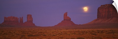 Moon shining over rock formations, Monument Valley Tribal Park, Arizona
