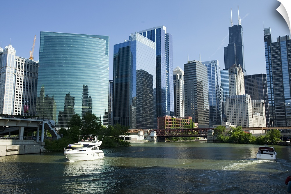 Low-angle view of buildings and skyline with waterfront filled with boats.