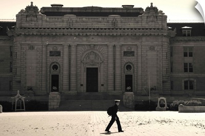 Naval cadet walking in front of Tecumseh Court, US Naval Academy, Maryland