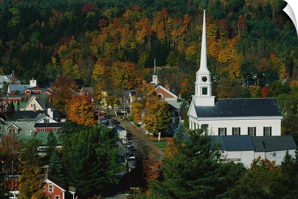 Large photo of fall foliage surrounding a small town in Vermont with an old Church on the right.