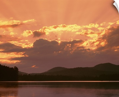 New York State, Adirondack Mountains, Rollins Pond, Sunlight and moody sky over the mountain and pond