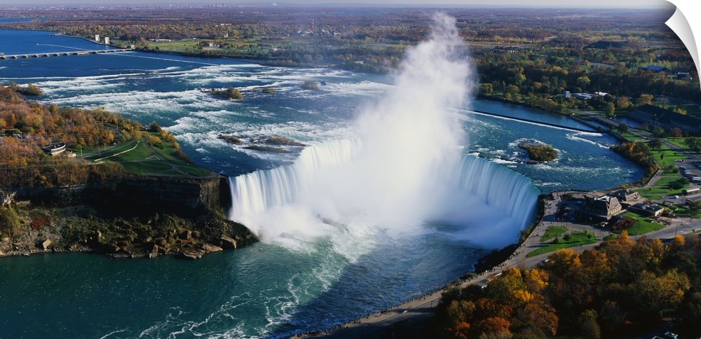 Aerial photo of Niagara Falls lined by Canada on one side and New York on the other.