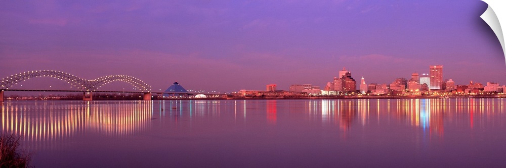 This photographic wall art a panoramic cityscape of Memphis lights reflecting on the Mississippi River at dusk.