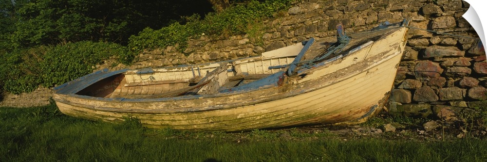 Old fishing boat in front of a stone wall, Westport, County Mayo, Republic of Ireland