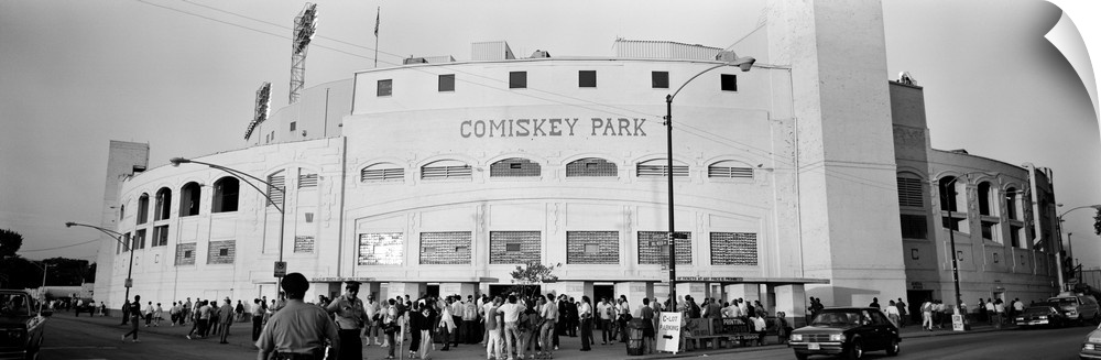 A crowd of people is shown as they enter the gates at Comiskey Park.
