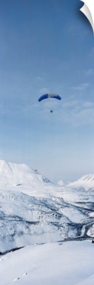 Person parasailing over a snow covered mountain, Thompson Pass, Valdez, Alaska