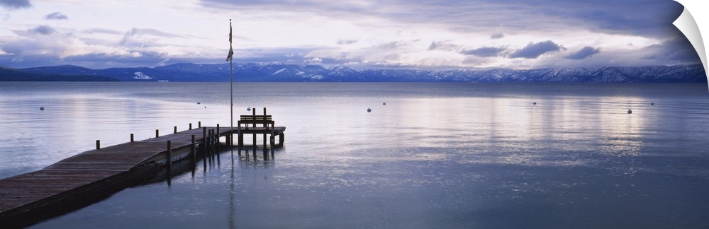 Large dock on Lake Tahoe in California with mountains in the background.