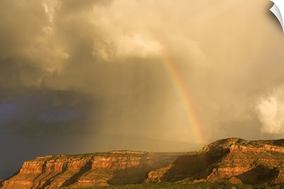 Rainbow Over Desert Landscape With Mesas