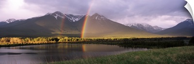 Rainbow over mountain range, Alberta, Canada