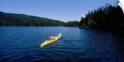 Rear view of a man on a kayak in a lake, Orcas Island, Washington State