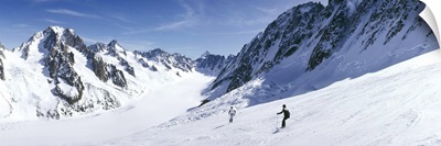 Rear view of two people skiing, Les Grands Montets, Chamonix, France