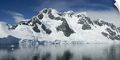 Reflection of a snow covered mountain in water, Antarctic Peninsula, Antarctica