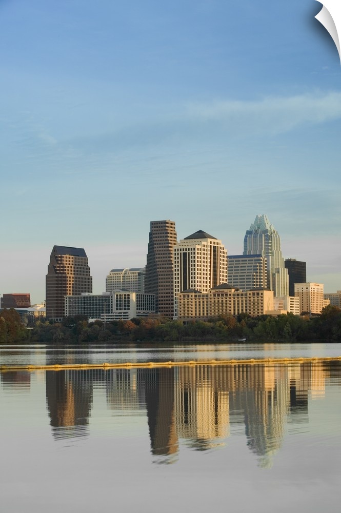 Skyscrapers in Austin reflect down in the body of water that sits just in front of the city.