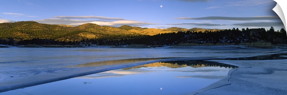 Large photo on canvas of a lake with rolling hills in the distance and a moon shining bright in the sky reflected on the l...