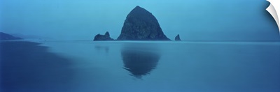 Reflection of rock in water, Haystack Rock, Cannon Beach, Clatsop County, Oregon