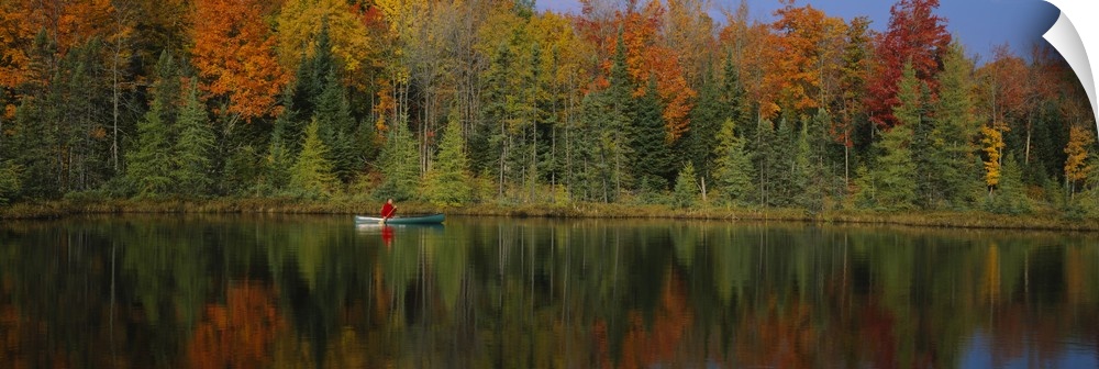 A lone canoer on the lake during the fall in Antigo, Wisconsin.