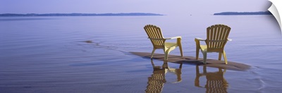 Reflection of two adirondack chairs in a lake, Lake Michigan, Michigan