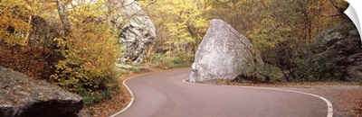 Road curving around a big boulder, Stowe, Lamoille County, Vermont,