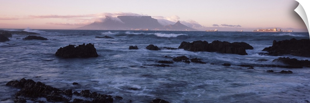 Rocks in the sea with Table Mountain in the background, Bloubergstrand, Table Mountain, Cape Town, Western Cape Province, ...