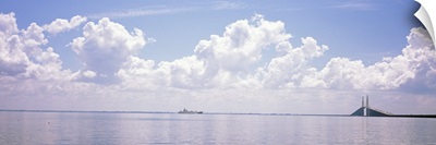 Sea with a container ship and a suspension bridge in distant, Sunshine Skyway Bridge, Tampa Bay, Gulf of Mexico, Florida,