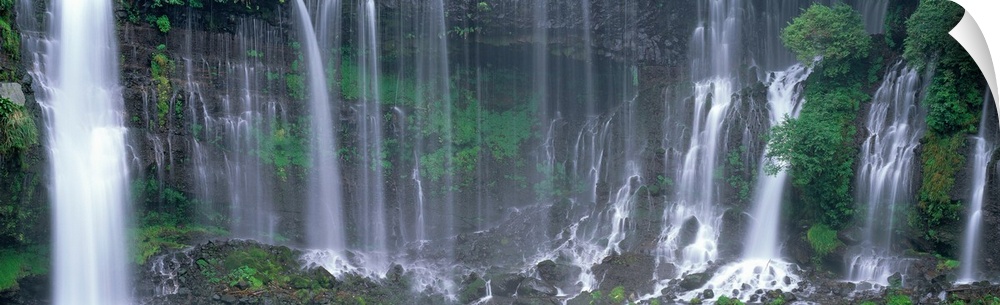 Wide angle, photograph on a large canvas of Shiraito Falls, surrounded by greenery, in Fujinomiya, Shizuoka, Japan.