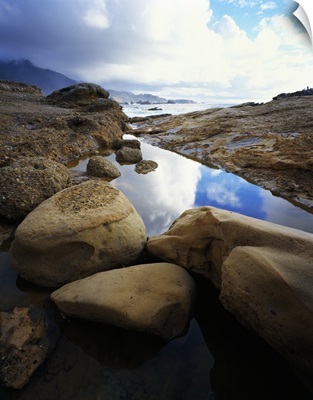 Shoreline rocks and reflective tide pool, Point Lobos State Reserve, California
