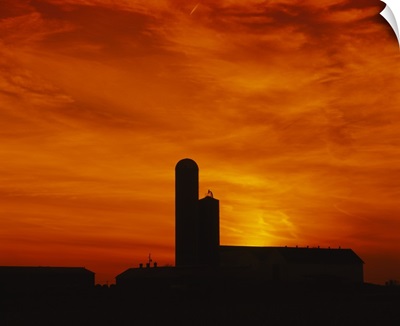Silhouette of a barn and a silo at sunset, Pennsylvania