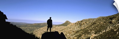 Silhouette of a hiker standing on a rock, Cederberg Mountains, South Africa