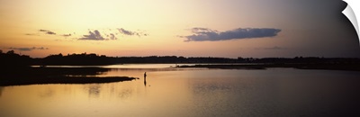 Silhouette of a person fishing in a lake at dusk, Rye, Rockingham County, New Hampshire